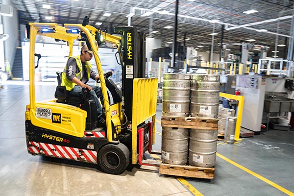 Man on a Yellow forklift in a warehouse