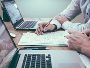 image of two men brainstorming over paper